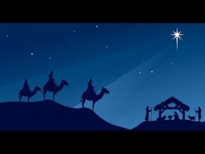 The magi following a star to the stable.