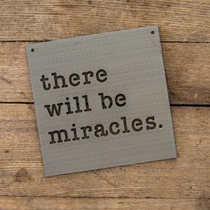 A sign says, "There will be miracles."