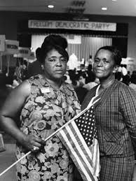 Fannie Lou Hamer,, carrying flag, leads Freedom Democratic Party delegation.