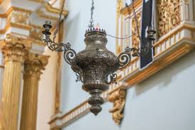 A sanctuary lamp occupies a prominent position in this church building.