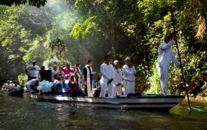 A group of pilgrims travel by boat on the Caraparu River in Santa Izabel do Para, Brazil.