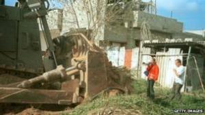 A bulldozer, Rachel Corrie, and a Palestinian home.