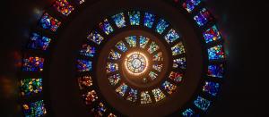 A series of stained glass windows in a spiral.