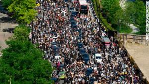 A street crowded with marchers protesting after the police killing of George Floyd.