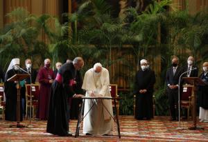 Flanked by faith leaders from world's major religions, Pope Francis signs appeal to governments.