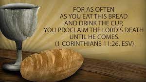 A slver cup and a loaf of bread with the legend:: For as often as you eat t his bread and drink the cup, you proclaim the Lord's death until he comes. (1 Corinthians 11:26, ESV)