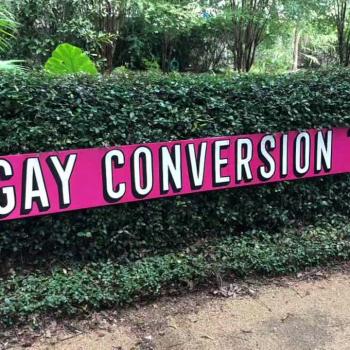 Gallery Owner Uses “Gay Conversion Therapy” Sign to Resolve Church Parking Feud