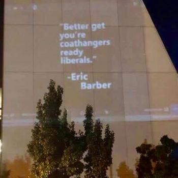 Lawmaker’s Coat Hanger Abortion Quote Projected on Building During City Meeting