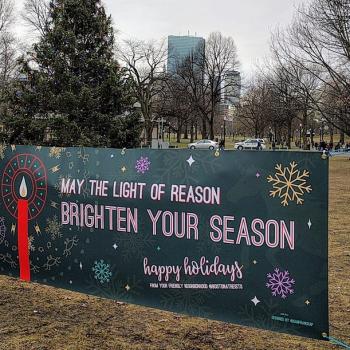 Sign on the Boston Common Reads, “May the Light of Reason Brighten Your Season!”